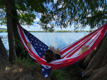 Load image into Gallery viewer, Co-founder, Amanda, sitting in the &#39;murica hammock that is hanging between two trees on the shore of Lady Bird Lake in Austin, TX
