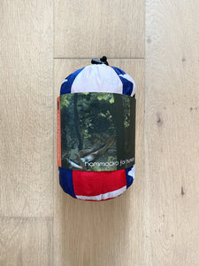 'Murica hammock with a front view of the hung hammocks packaging on a light oak hardwood floor 